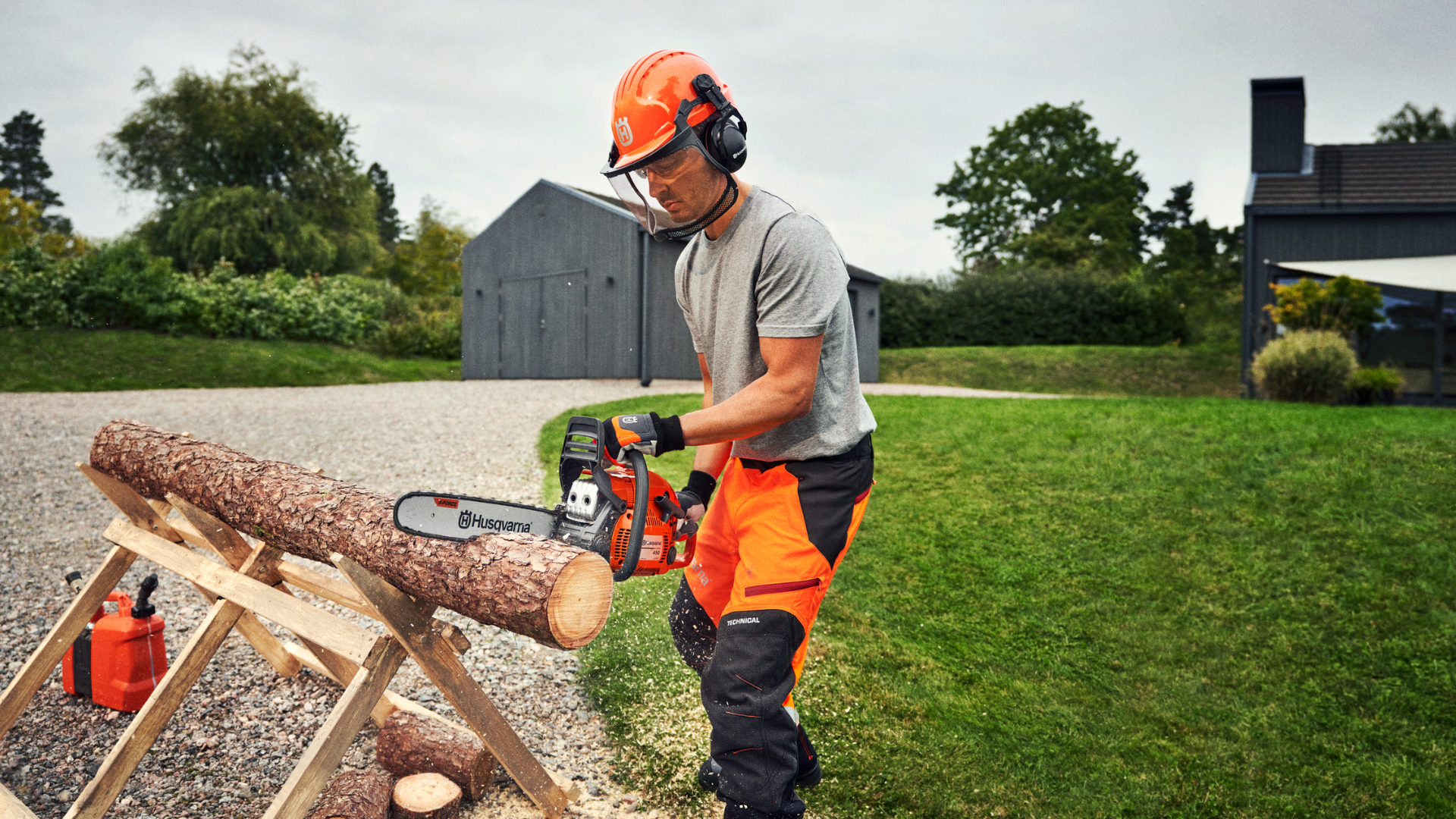man cutting log of wood with chainsaw